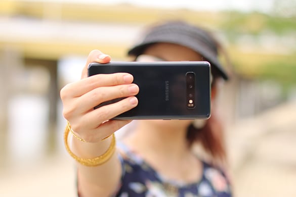 Woman recording selfie video on her phone