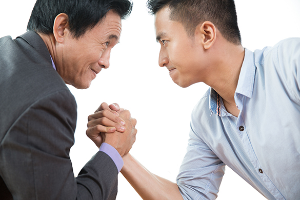 Two business men arm wrestling stubbornly